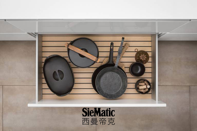 Pots and pans on GripDeck in light oak from SieMatic wooden kitchen accessories