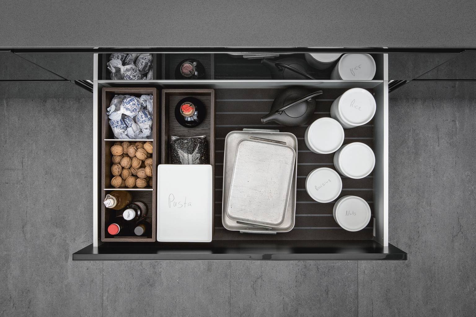 Porcelain jars and organization inserts from SieMatic Aluminum Interior Accessories System